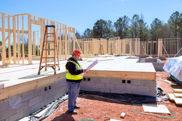 Construction inspector used blueprints to verify quality of work being performed during construction process